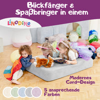 Spielmatte in Grau, genutzt als Hüpfpolster und Lesefläche für Kinder